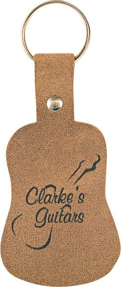 Suede guitar-shaped key fob. Available in sand colored suede with black printing only.